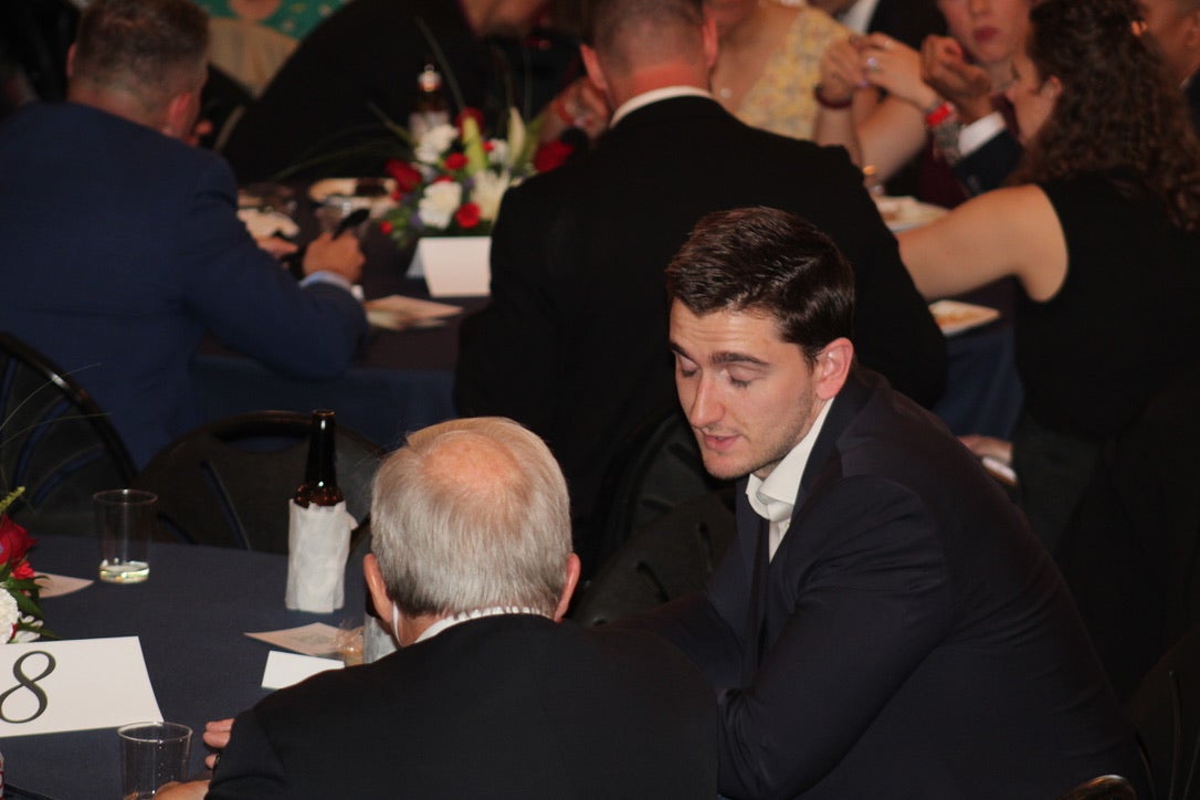two people speaking at a table