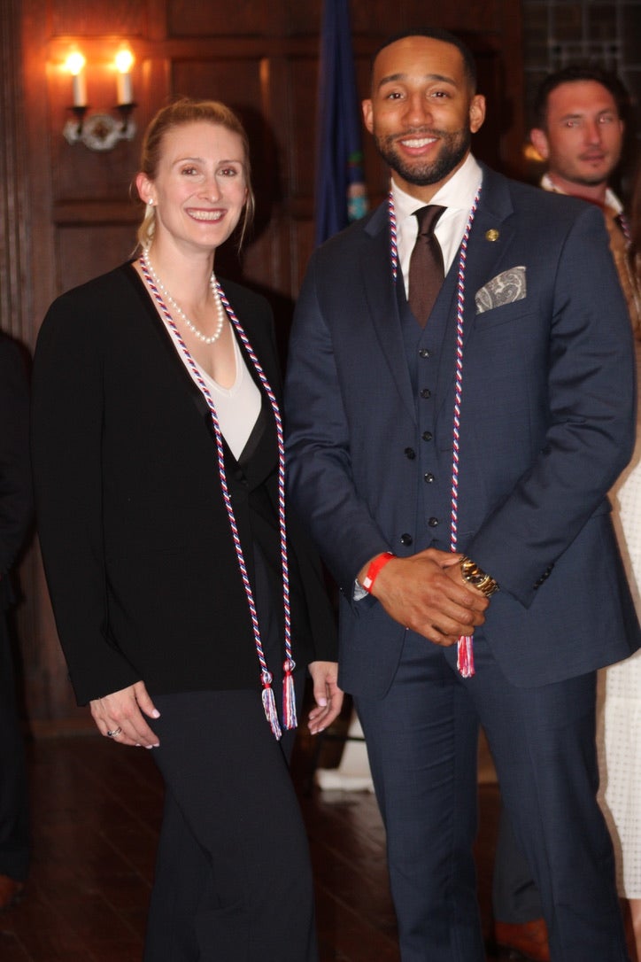 two students with military-connected graduation cords
