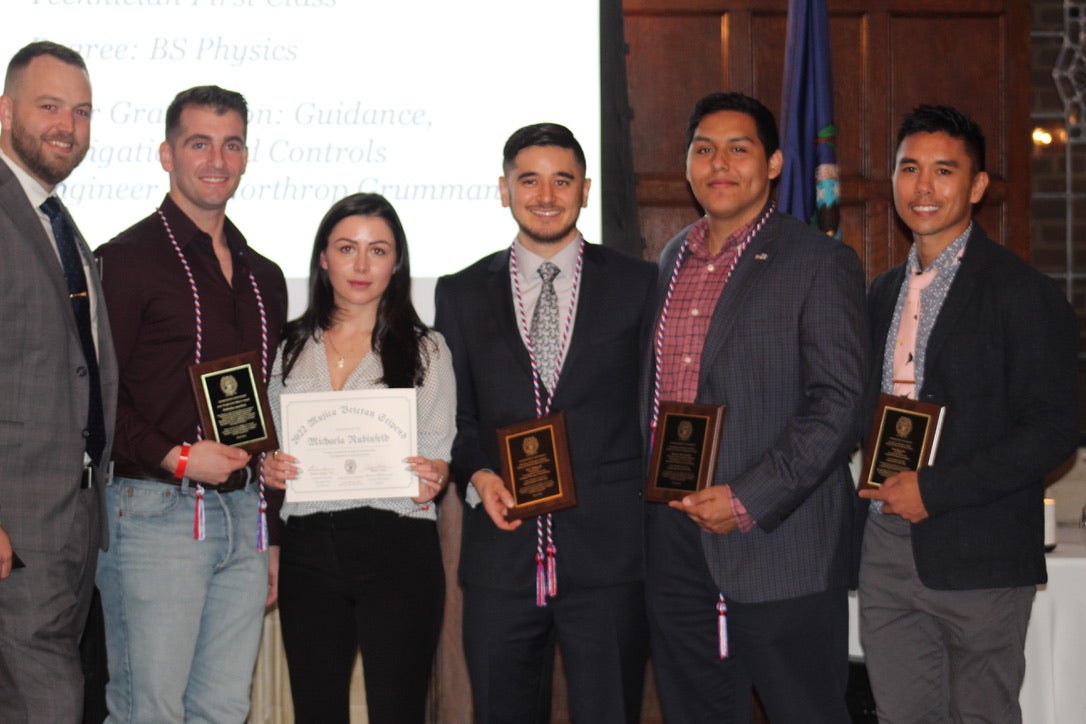 Group of students holding plaques and certificates