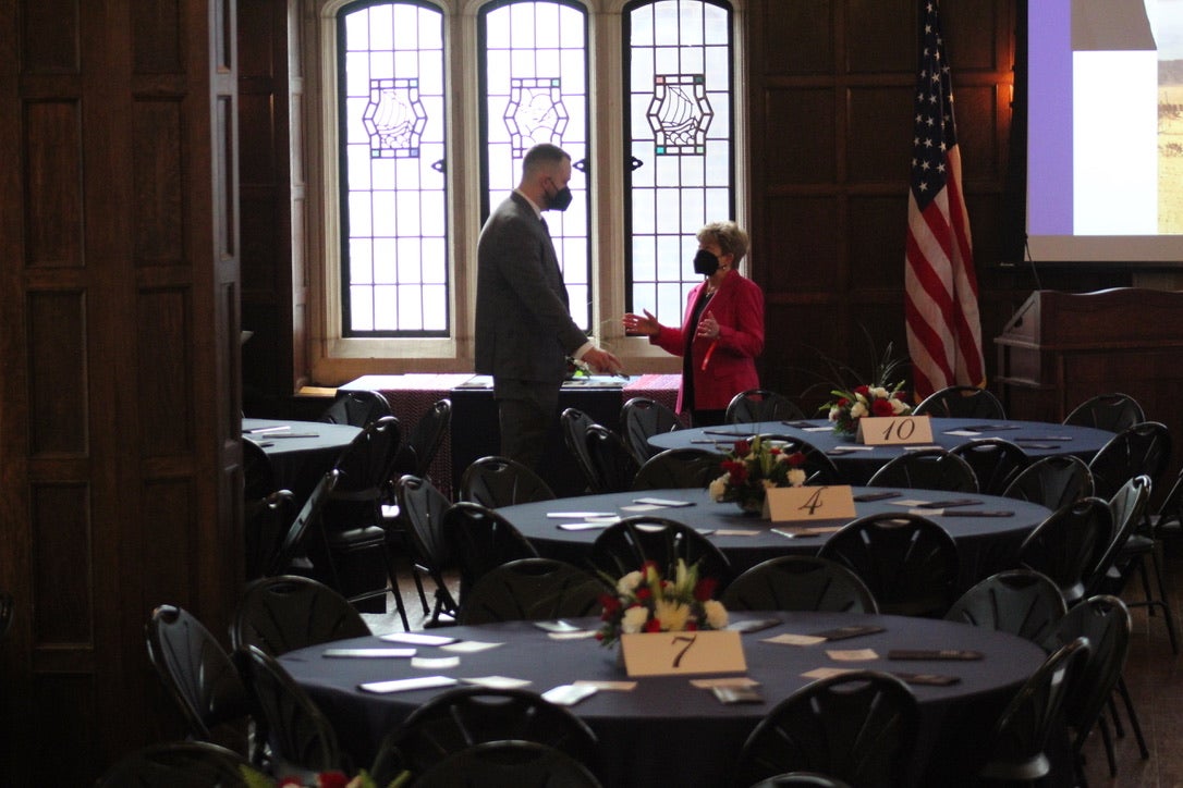 two people speaking behind decorated tables