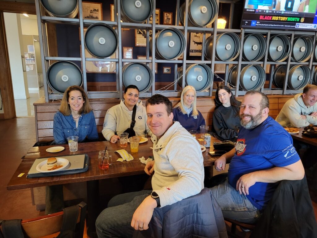 people smiling for a picture at a restaurant table