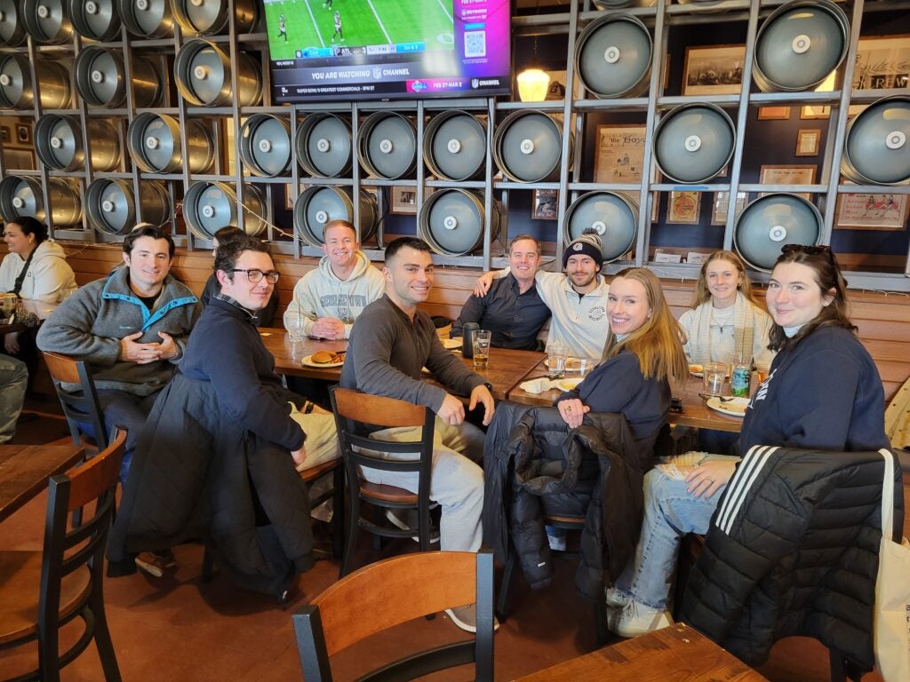 people smiling for a picture at a restaurant table