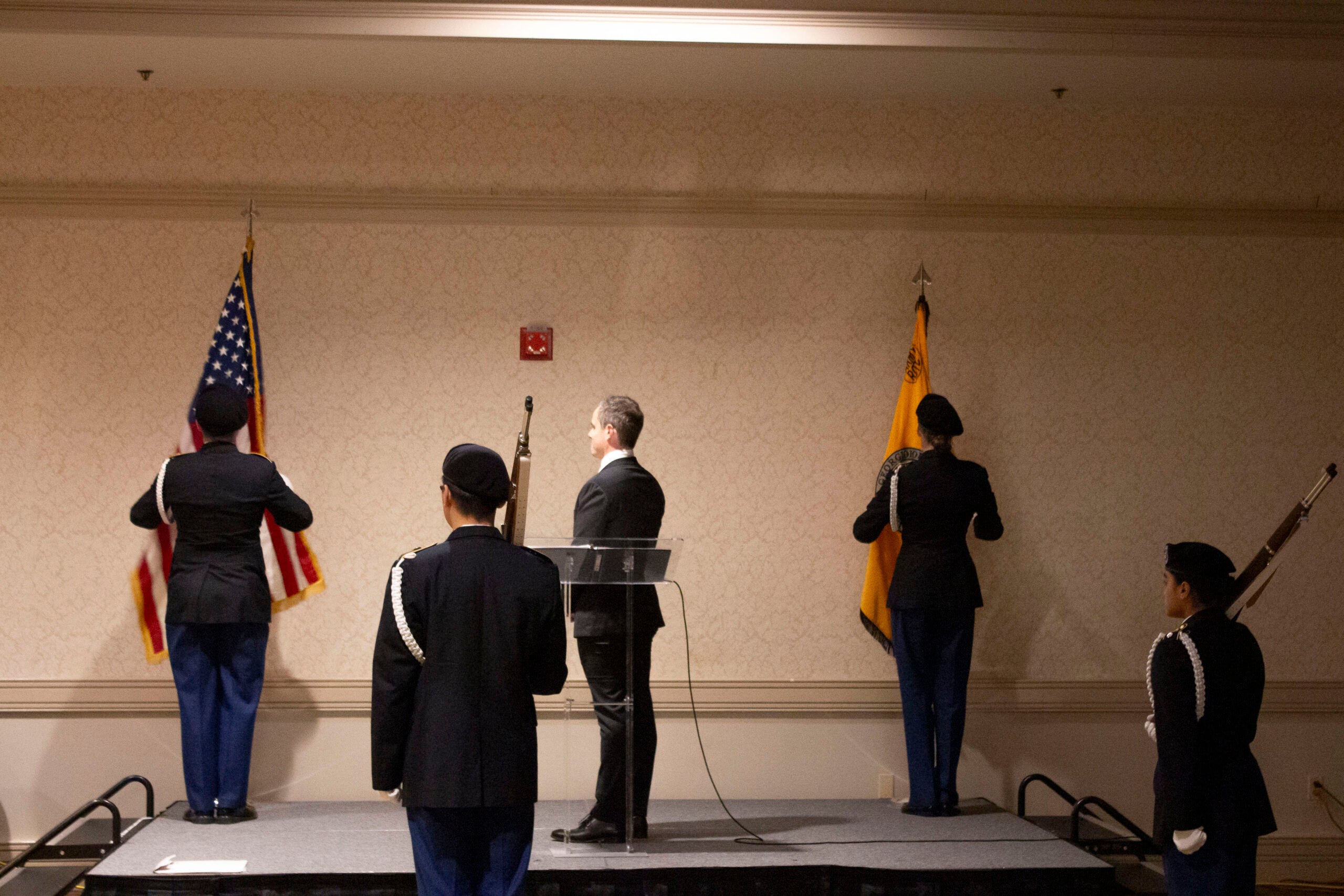 Presenter and Army ROTC color guard saluting during national anthem