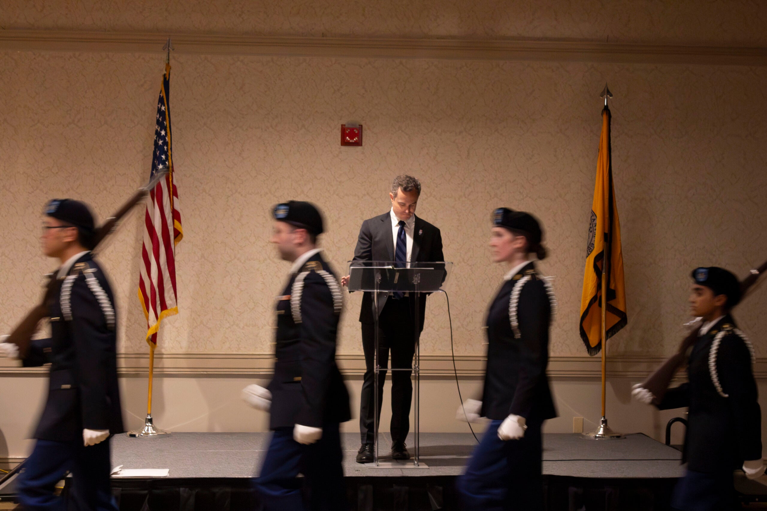 Army ROTC color guard walking in front of stage