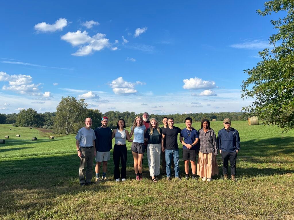 group of people posing for a picture in a field