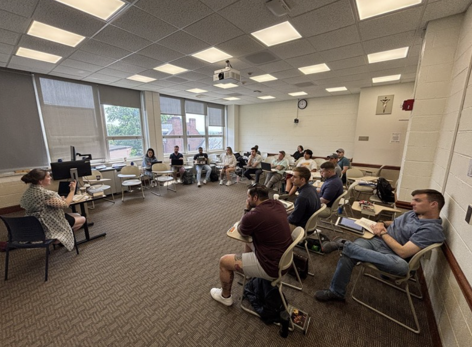 students sitting at desks in a circle 