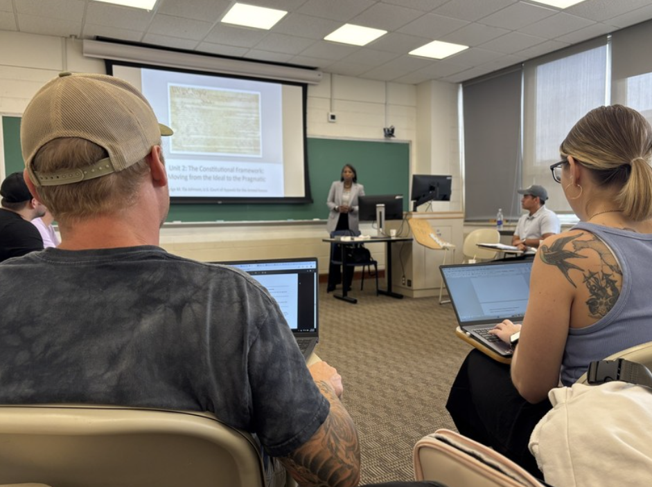 students sitting in a classroom watching a presentation