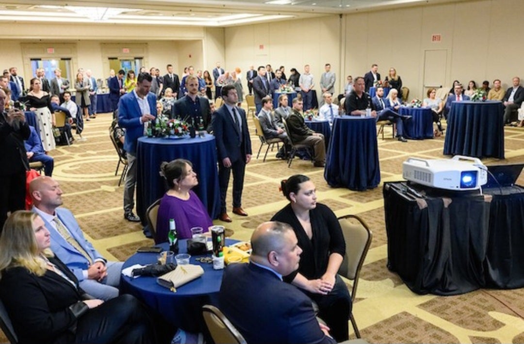 Guests sitting and standing at tables