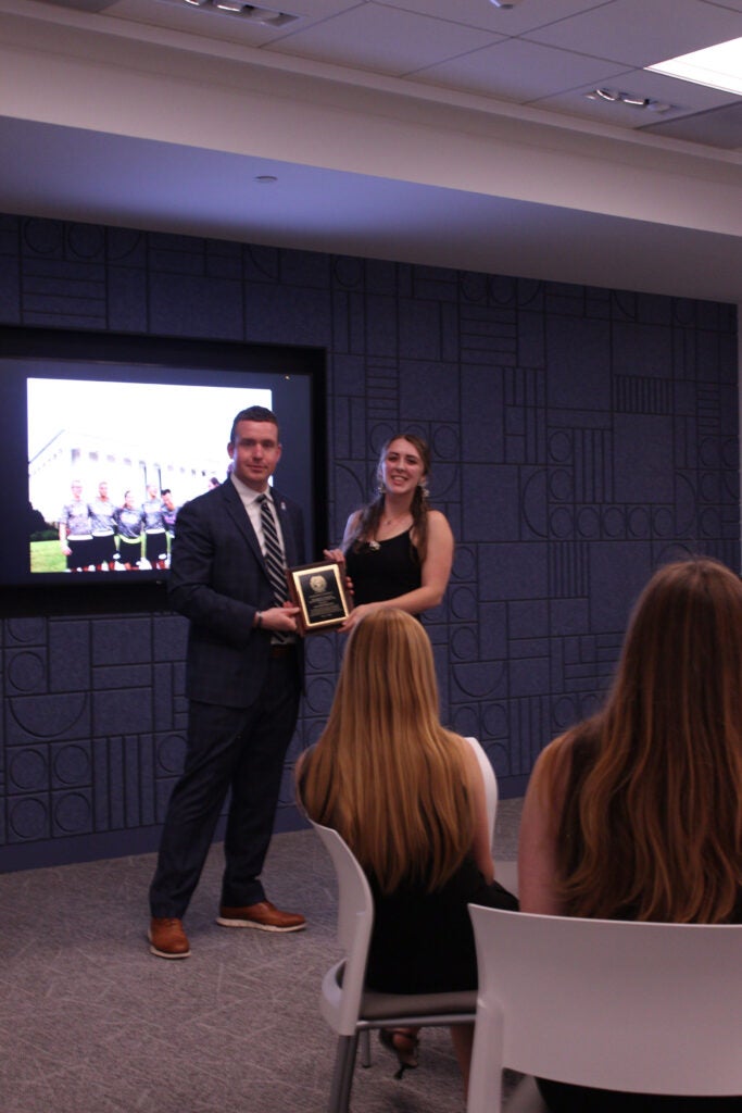 Autumn Dunlop and Stephan Murphy posing for photo with plaque