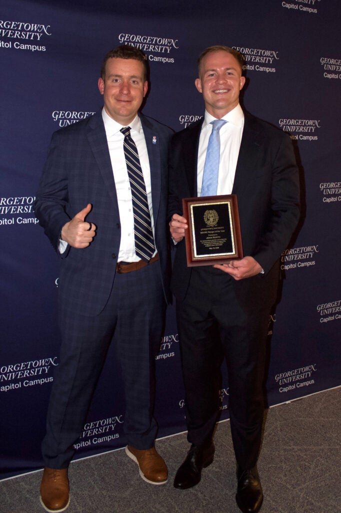 Greg Doty and John Kurth posing for photo with plaque