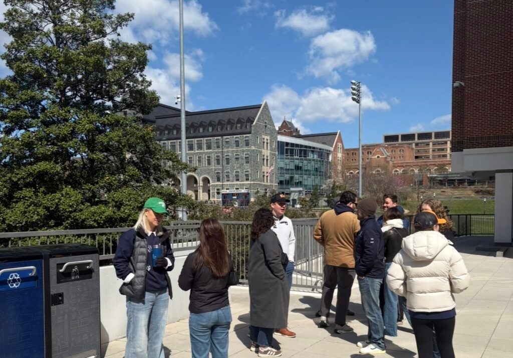 A group of people mingling on a patio 