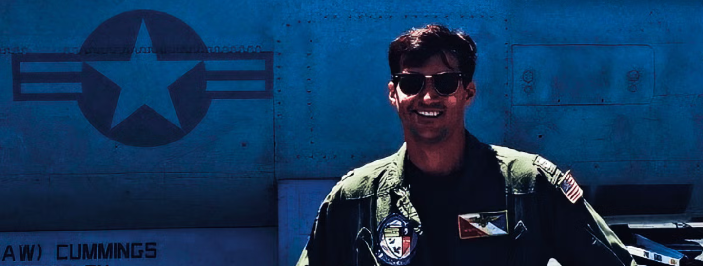 A man in uniform standing in front of a military plane