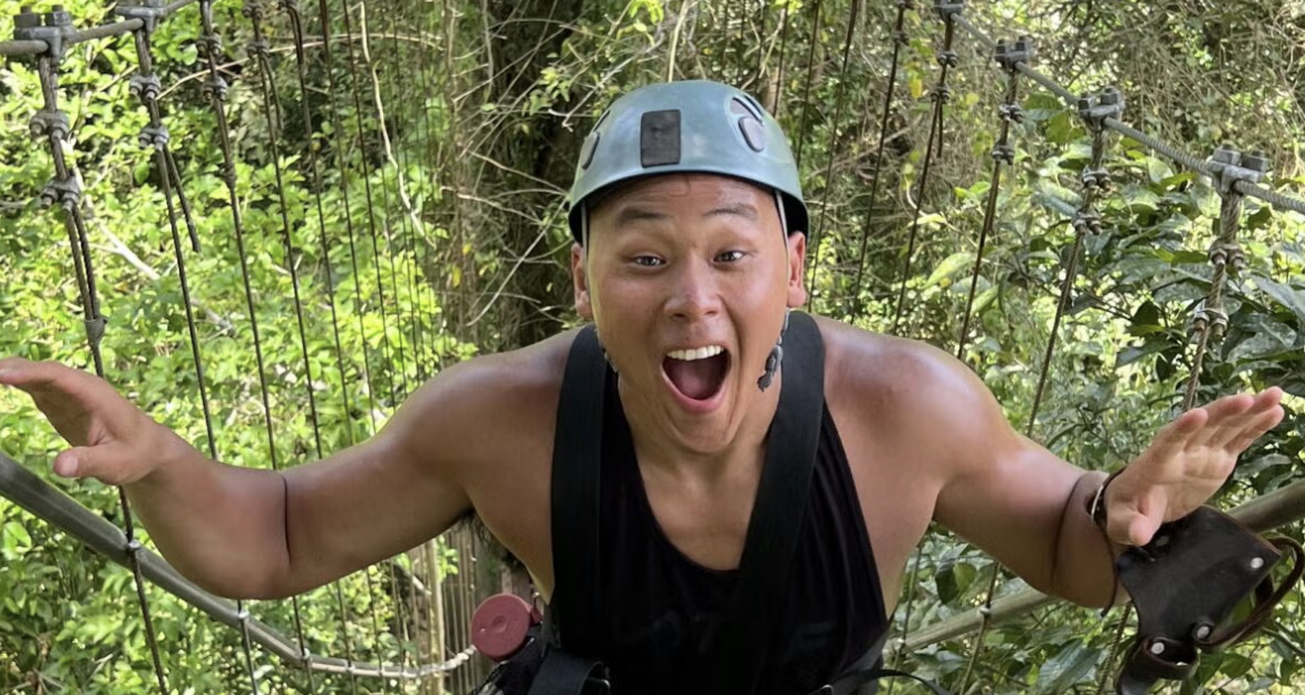 A man wearing a helmet with trees in the background