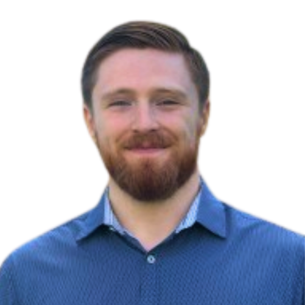 A white man with short red hair and a beard wearing a blue button down